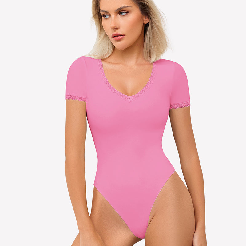 Pink V-neck bodysuit with lace trim, offering light smoothing and a flattering fit.
