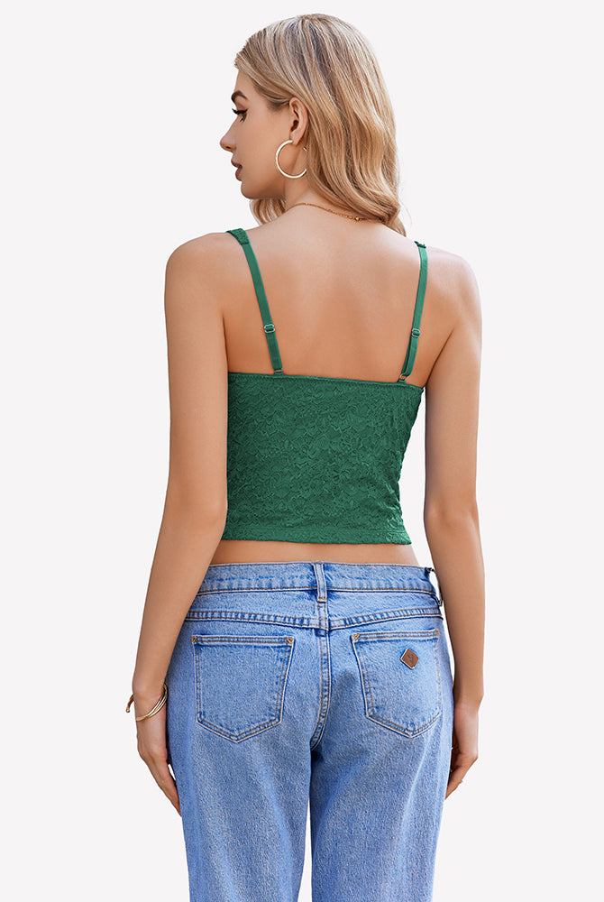 Green lace crop top with adjustable straps, perfect for party or date night, paired with blue jeans.