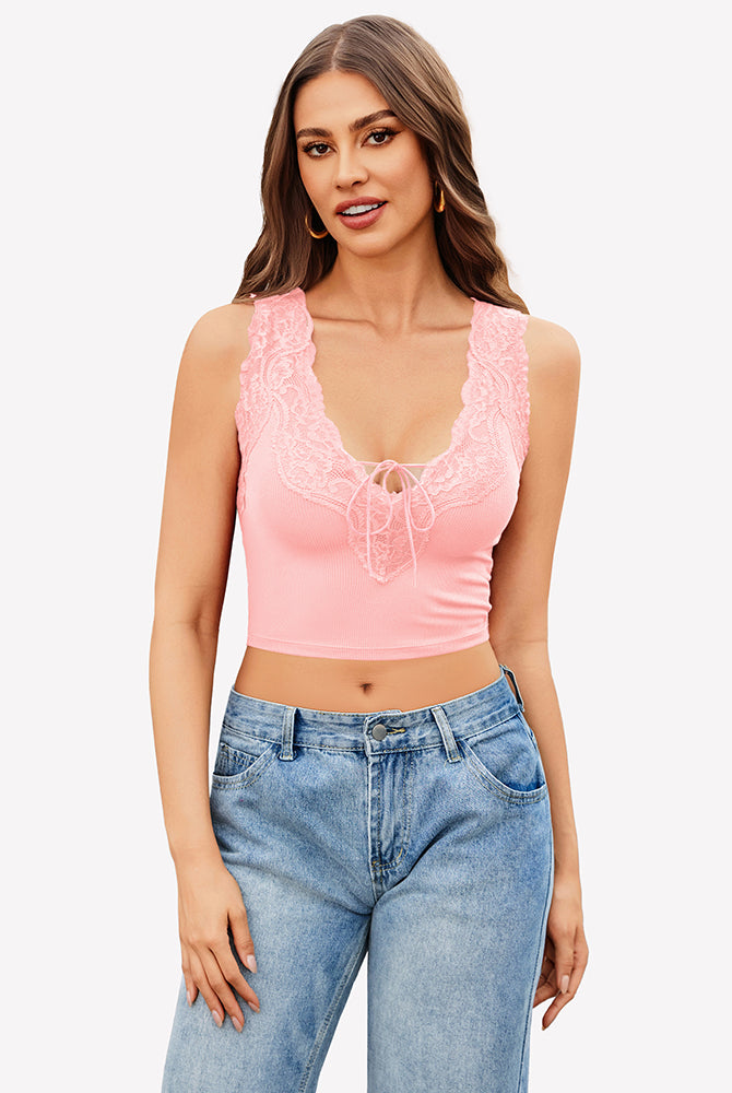 Pink V-neck crop top with lace trim and tie-up front, paired with jeans. Sexy and charming style.