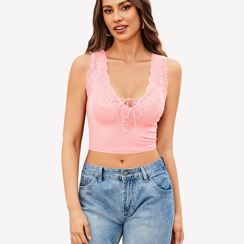 Pink V-neck crop top with lace trim and tie-up front, paired with jeans. Sexy and charming style.