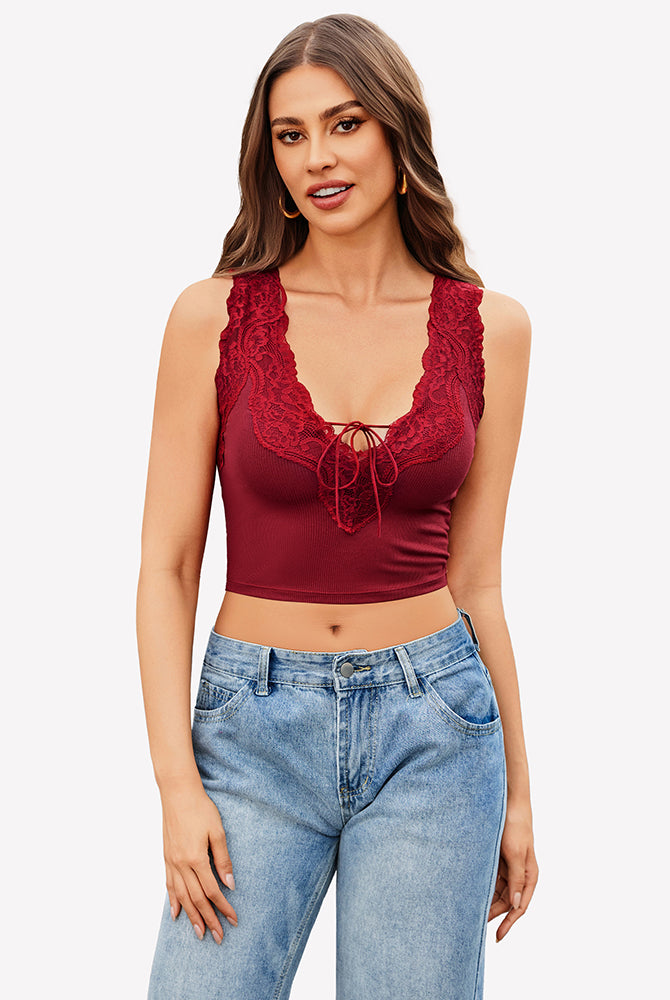 Burgundy V-neck crop top with lace trim, tie-up front, paired with jeans. Sexy and charming.
