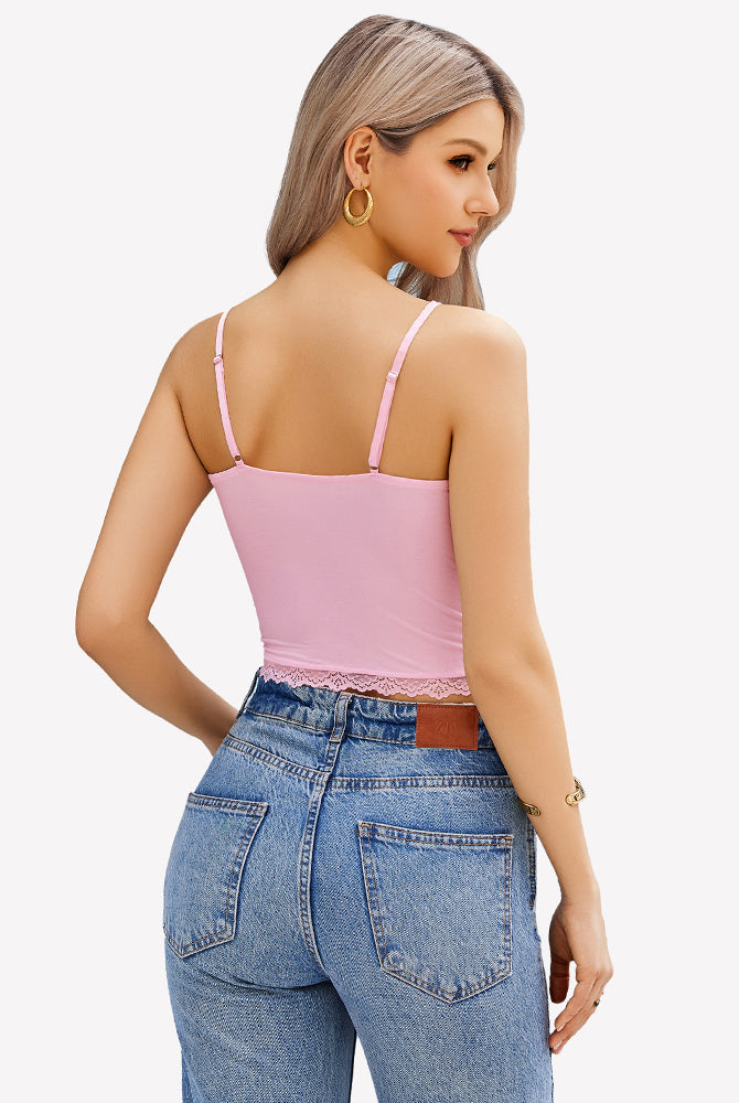 Pink lace cami top with adjustable straps, Y2K style, paired with blue denim jeans. Sexy camisole.
