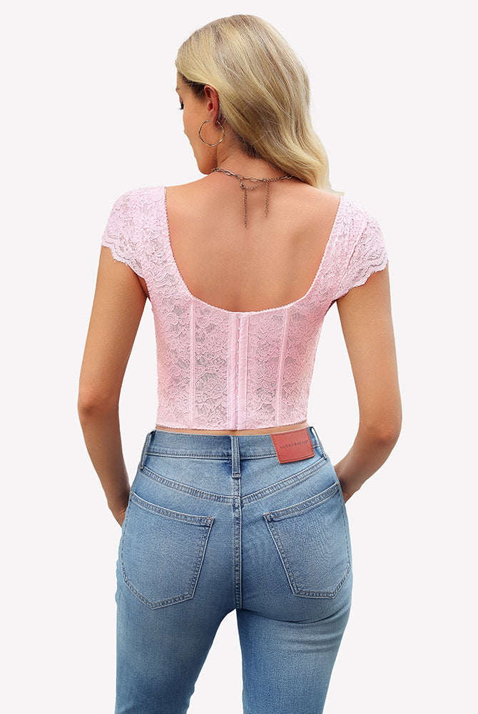 Pink floral lace bustier crop top with cap sleeves, styled with blue jeans. Sexy lingerie for women.