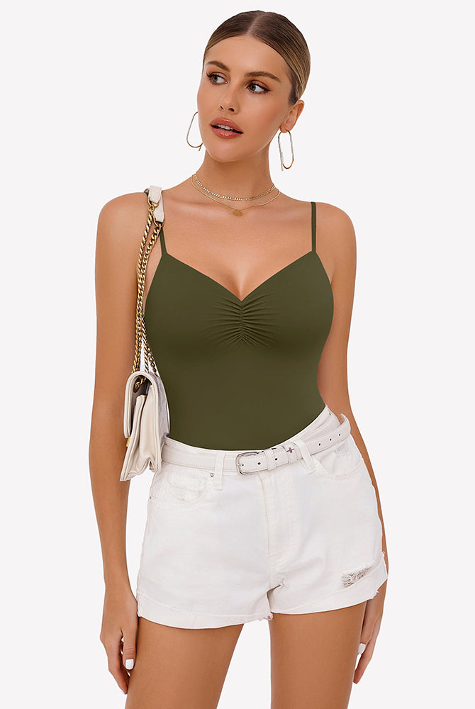 Olive green ruched V-neck thong bodysuit with adjustable straps, paired with white shorts