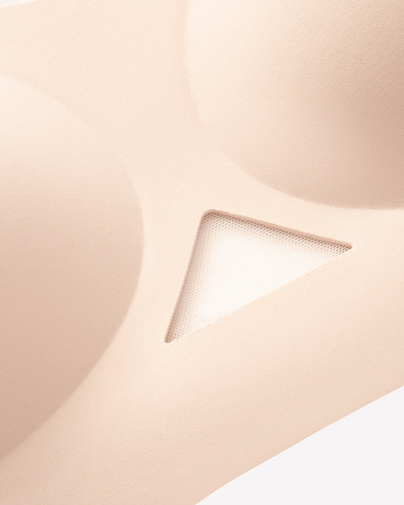Close-up of nude padded jelly bralette fabric with triangle mesh cutout detail.