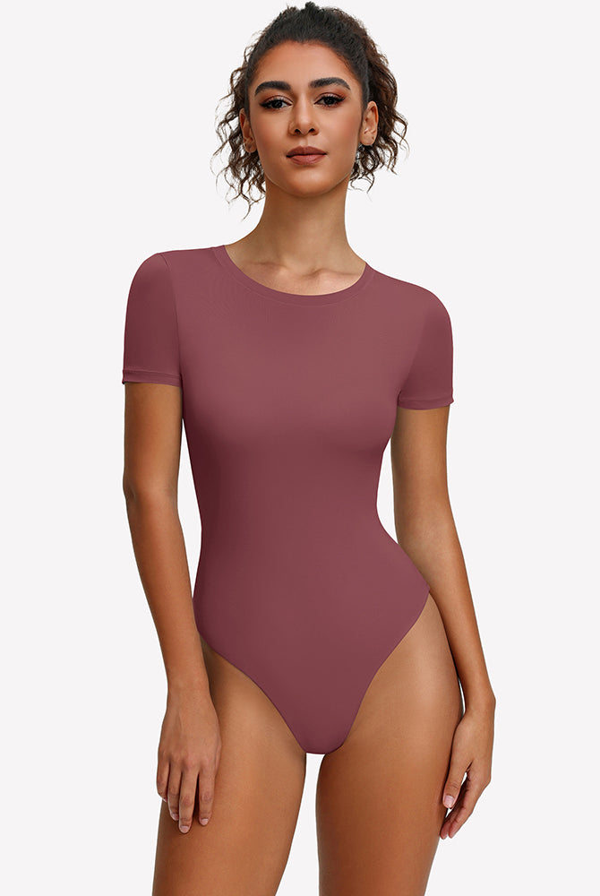 Purple-red short-sleeve snap bodysuit, fitted one-piece leotard top.