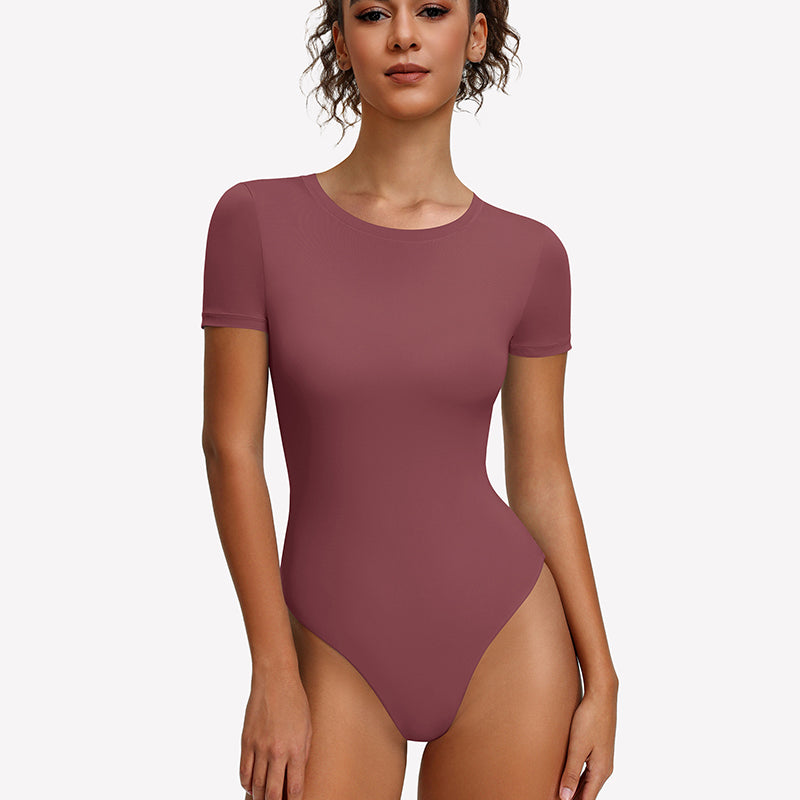 Purple-red short-sleeve snap bodysuit, fitted one-piece leotard top.
