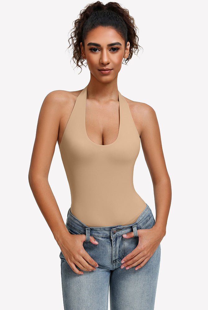 Beige halter bodysuit with deep scoop neckline, worn with blue jeans