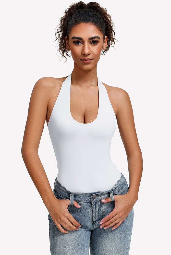 White halter bodysuit with deep scoop neckline, worn with blue jeans