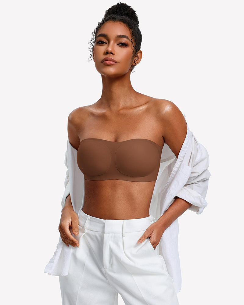 Strapless wireless bra in taupe-brown with smooth molded cups, paired with an open shirt