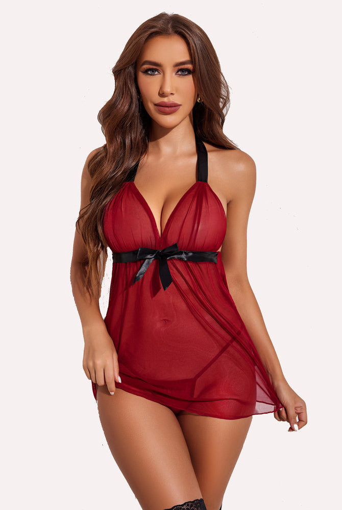 Red halter babydoll lingerie set with black bow and sheer mesh. Comfortable and sensual design.