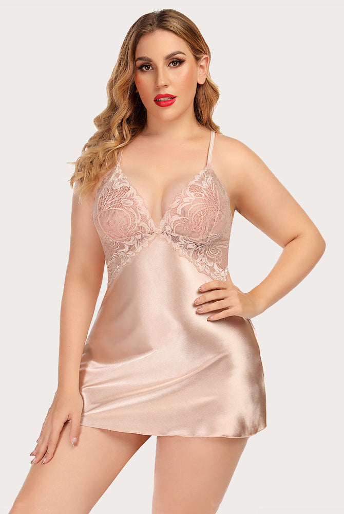 Plus-size model in blush pink satin nightdress with lace V-neck, adjustable straps. Sexy lingerie.