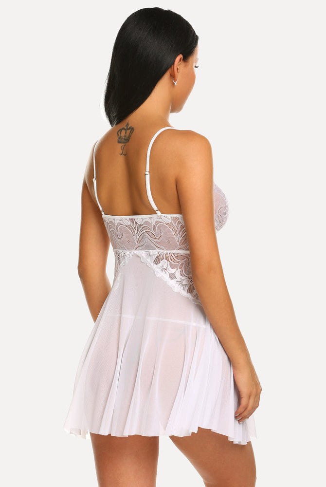 White lace babydoll lingerie. Bridal nightwear with adjustable straps and a flowing, sheer skirt.