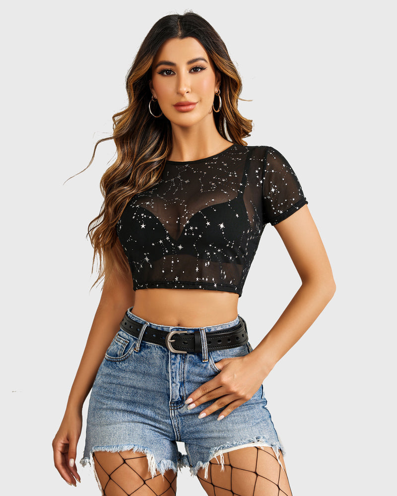 Black mesh crop top with star print, paired with denim shorts and a black belt. Sexy see through top