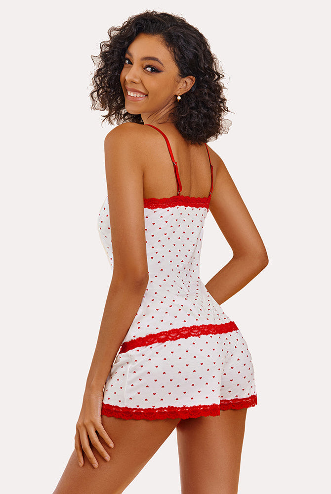 Heart print cami pajama set with red lace, modeled by a smiling woman. Sexy sleepwear.