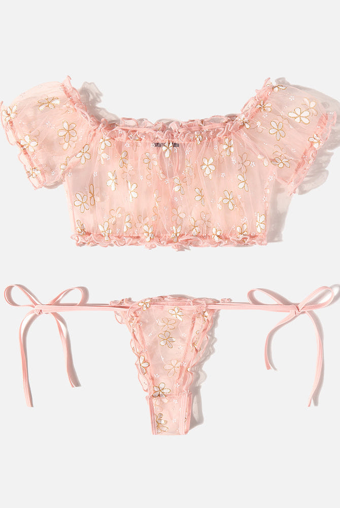 Pink floral lingerie set with ruffles, off-shoulder top, and tie-side thong