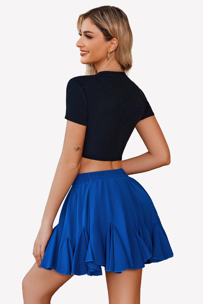 Pleated blue mini skirt with ruffle hem and black top. Stylish and comfortable for everyday wear.