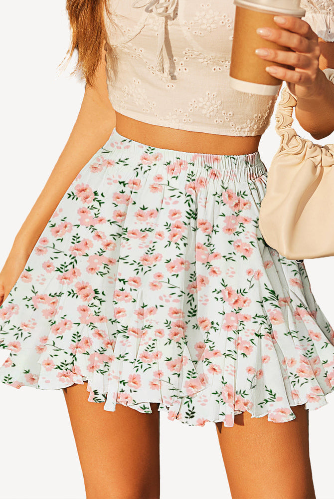 White floral pleated flared mini skirt with elastic waistband and ruffled tiers