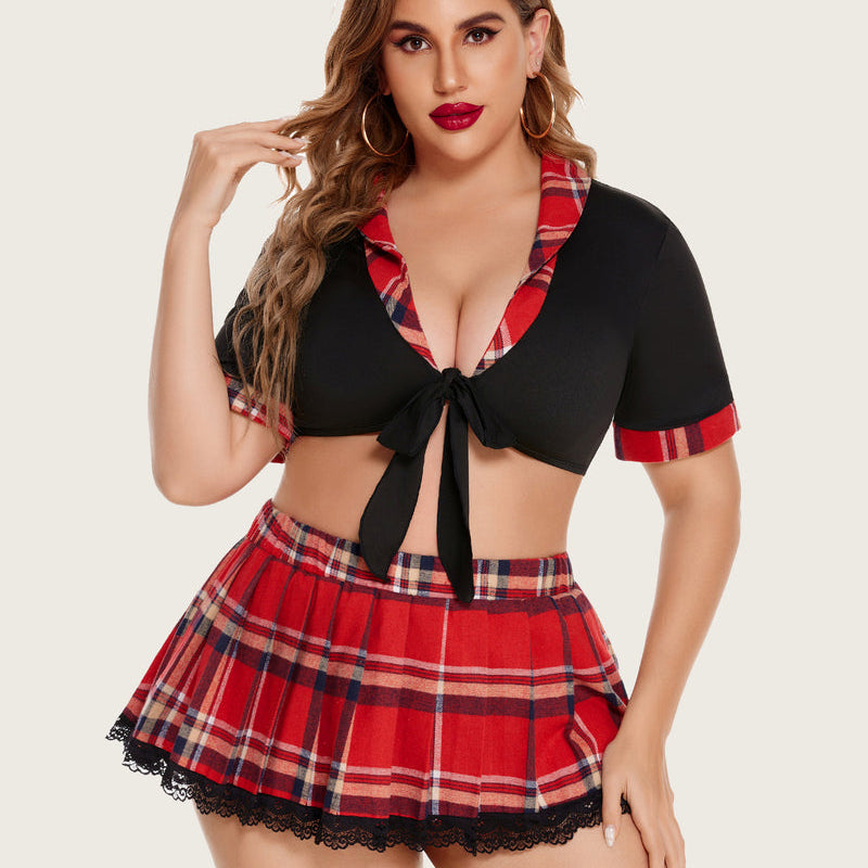 Plus size schoolgirl lingerie set: black tie top and red plaid mini skirt. Confident style.