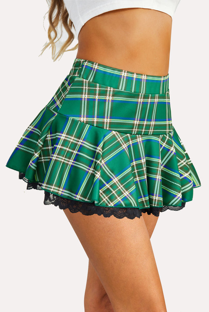 Green plaid pleated mini skirt with black lace trim. Flared A-line design for flattering fit.
