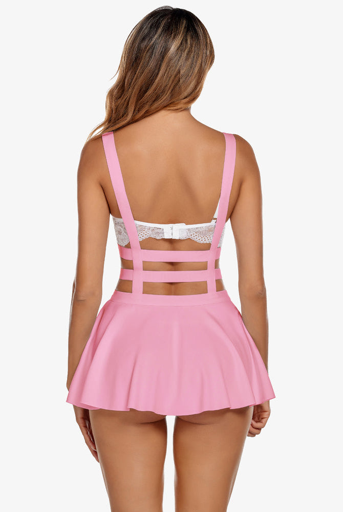 A-line pleated suspender skirt in pink with cross-back strap detail and lace trim