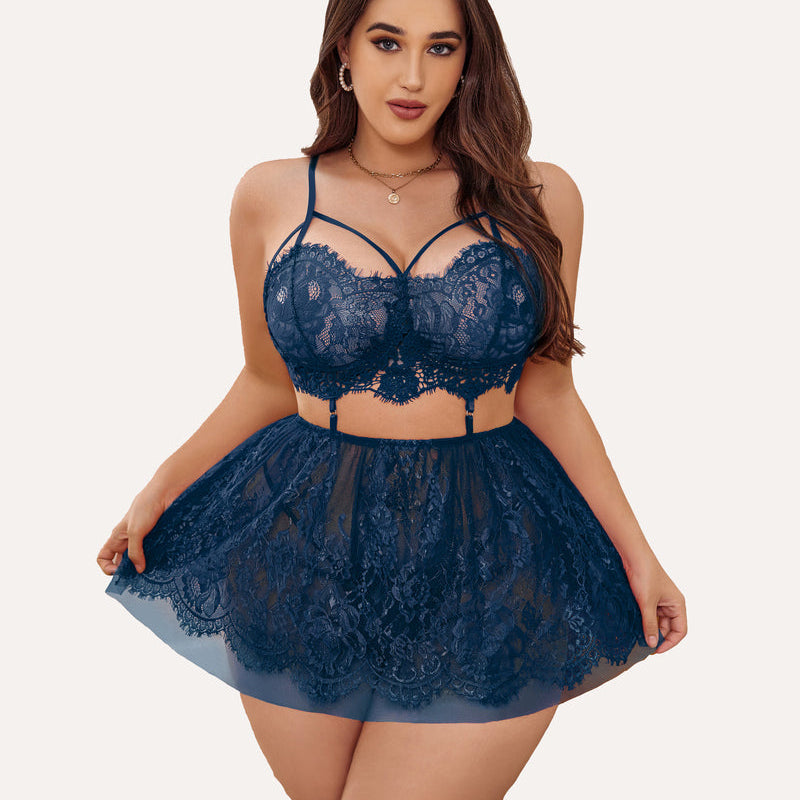 Plus size navy blue lace babydoll lingerie set with strappy bralette and sheer skirt.