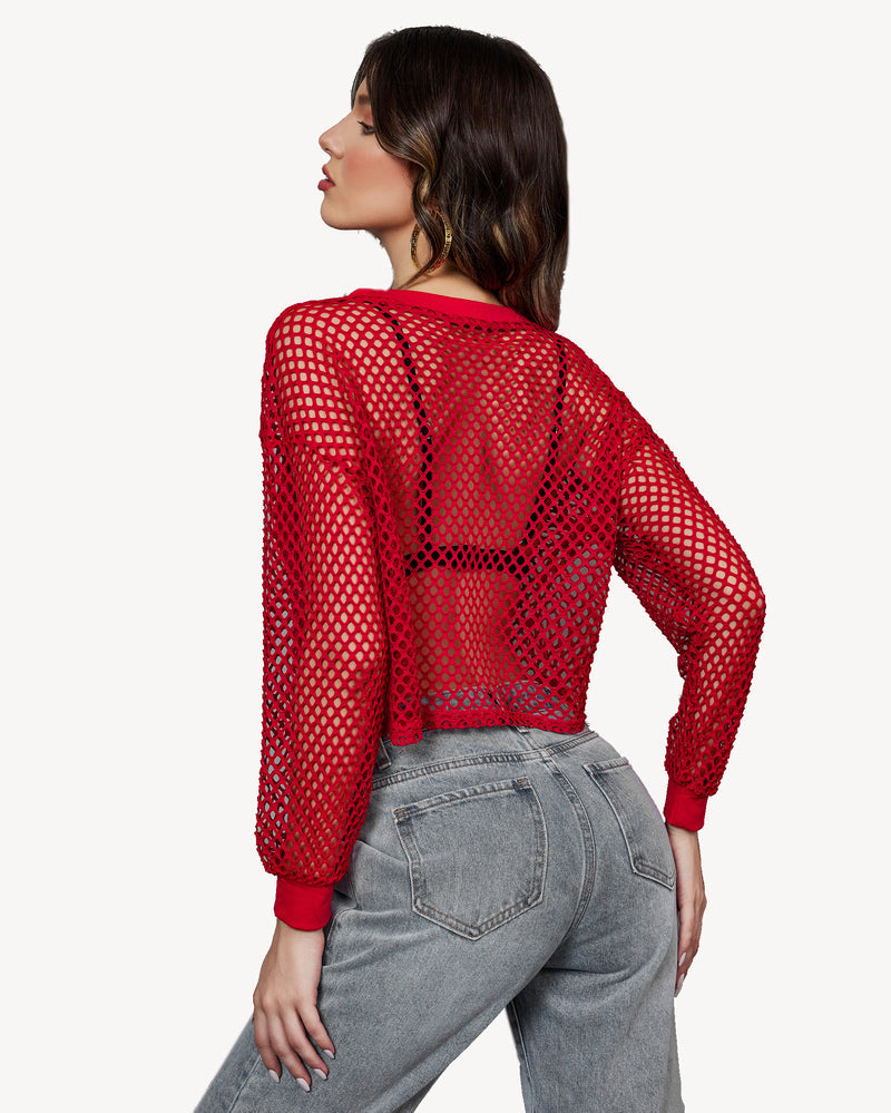 Red fishnet crop top with long sleeves and jeans. Sexy, fashionable see-through top.