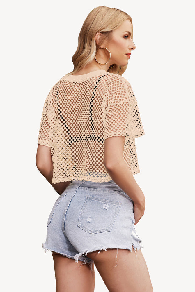Beige sheer fishnet crop top for women with denim shorts, a stylish and fashionable outfit.