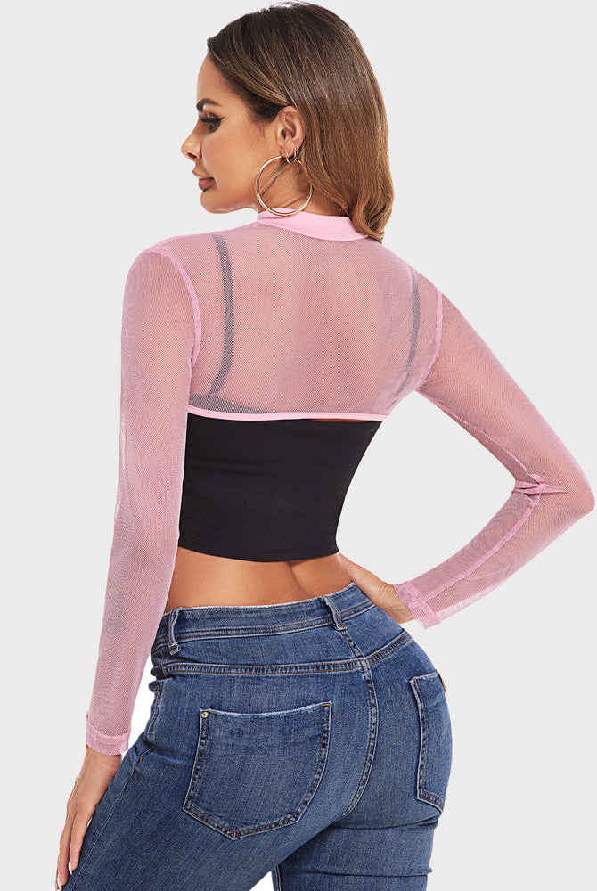 Pink mesh mock neck crop top with black bandeau and jeans. Confident lingerie style.