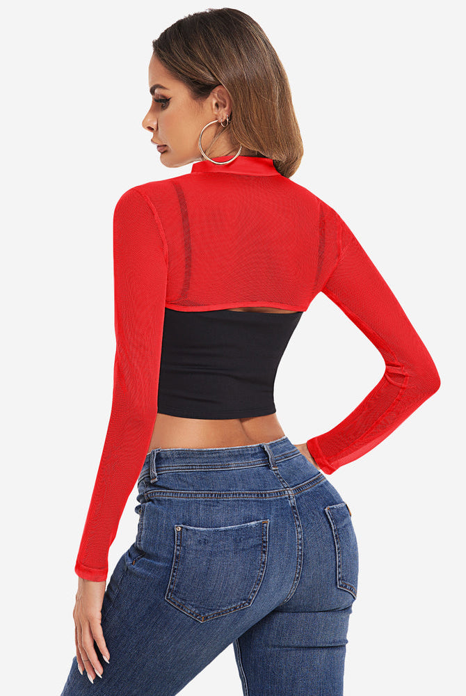 Red mesh mock neck long sleeve crop top over a black top and blue jeans
