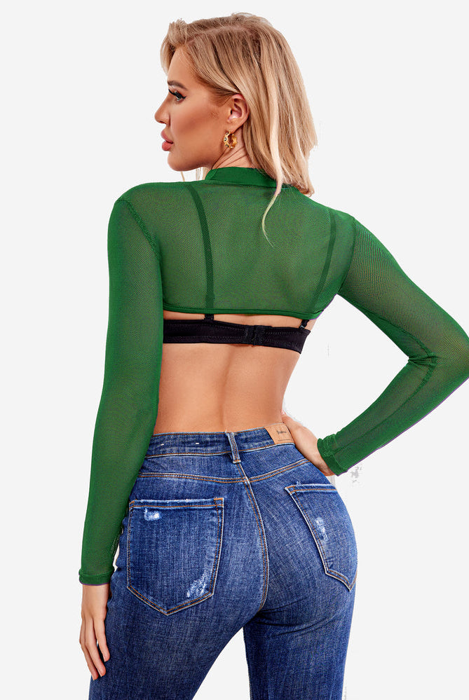 Green mesh mock neck crop top with long sleeves over black bra, and jeans. Confident lingerie style.