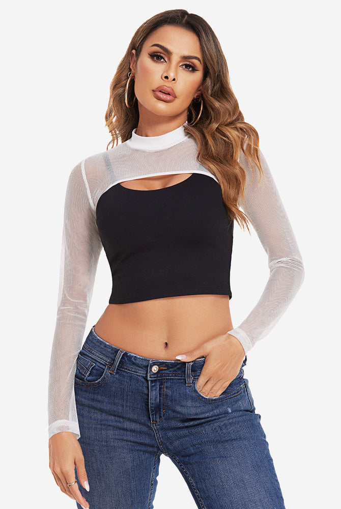 Mock neck long sleeve crop top with mesh overlay in white, model wearing jeans.