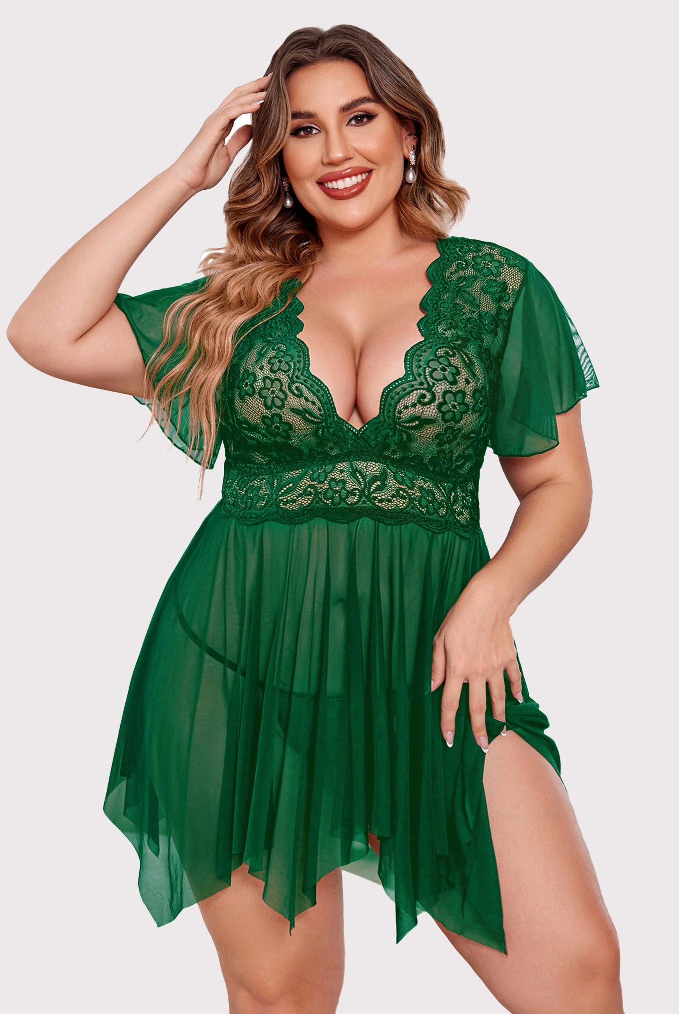 Plus size green babydoll lingerie with floral lace, deep V-neck and asymmetrical hem.