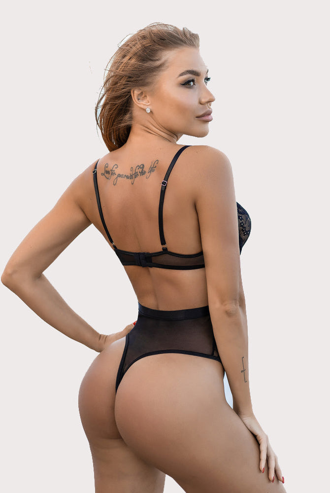 Black underwire lingerie set, sheer mesh bodysuit and thong, sexy look. Features a back tattoo