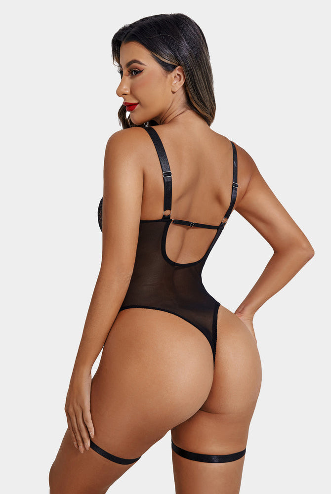 Black lace bodysuit with garter belt, cross straps, cutout design, scalloped trim. Sexy lingerie.