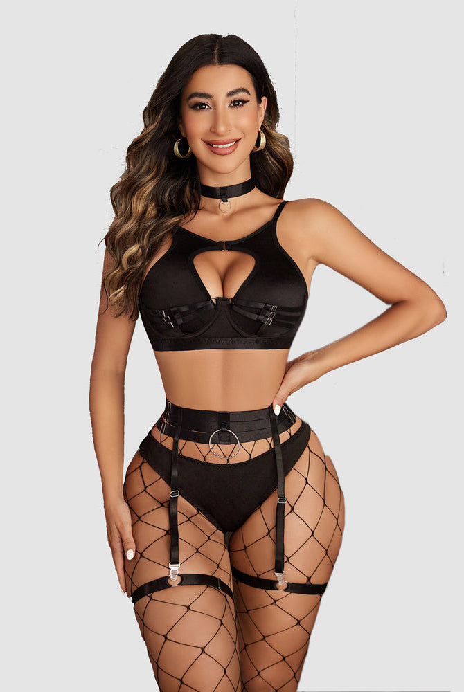 Black push-up lingerie set with cut-out bra, garter belt, and fishnet stockings. Sensual lingerie.