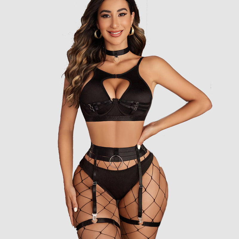 Black push-up lingerie set with cut-out bra, garter belt, and fishnet stockings. Sensual lingerie.