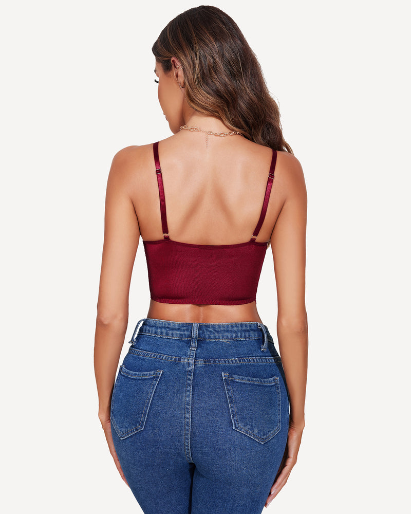 Burgundy bustier bralette, adjustable straps, paired with blue jeans. Confident style.