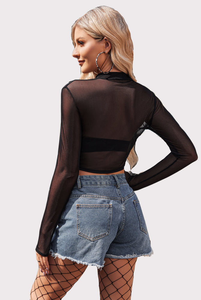 Long sleeve black mesh crop top. See-through design, stylish with denim shorts.