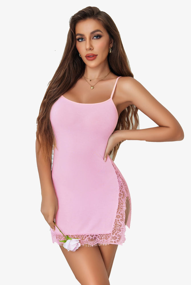 Pink slip nightdress with lace trim and side slit, offering comfortable and confident nightwear.