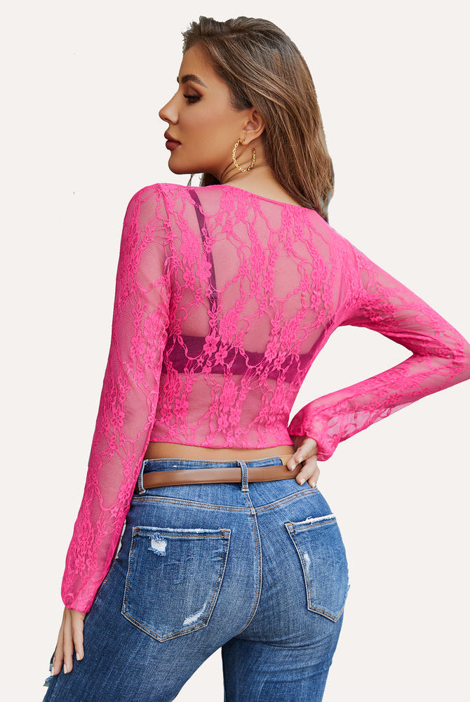 Hot pink floral lace sheer top with long sleeves, paired with blue jeans. Classy and elegant.