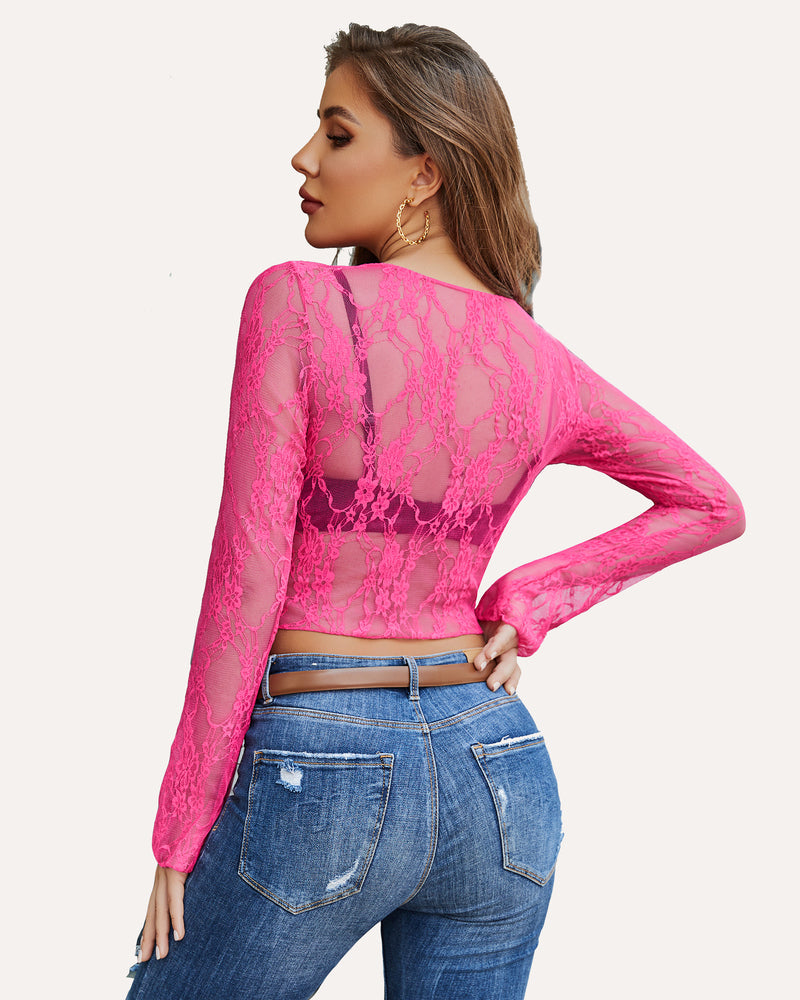 Hot pink floral lace sheer top with long sleeves, paired with blue jeans. Classy and elegant.