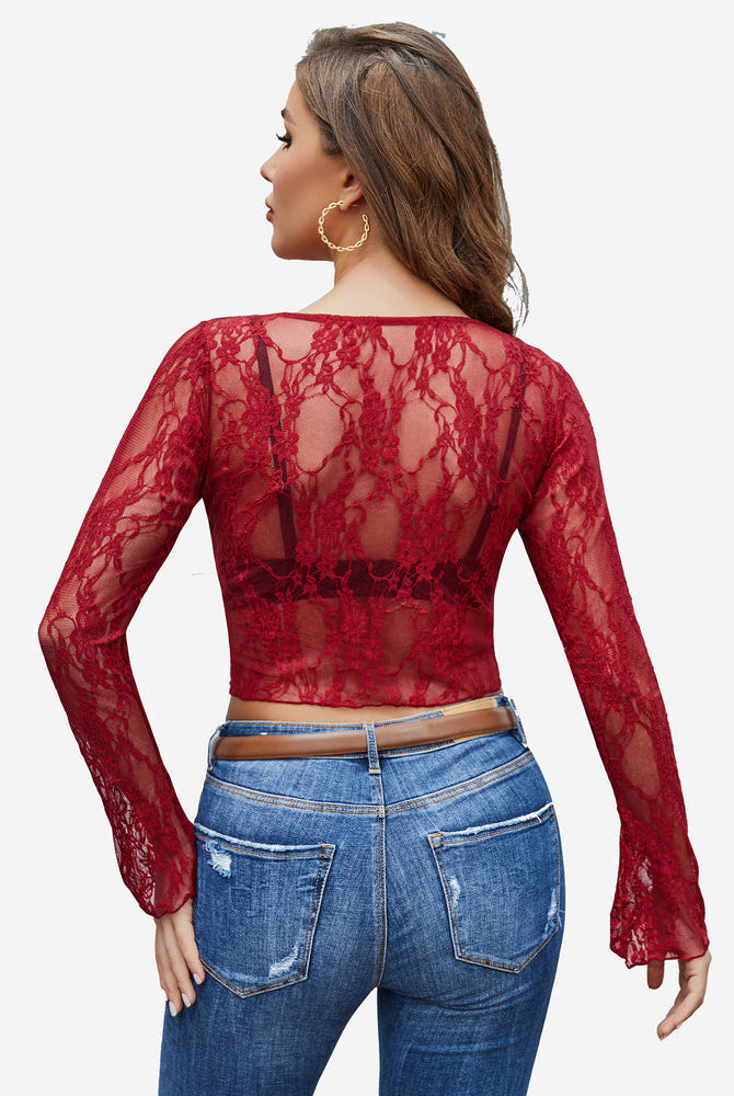 Burgundy floral lace sheer top with bell sleeves and blue jeans. Classy and elegant style.