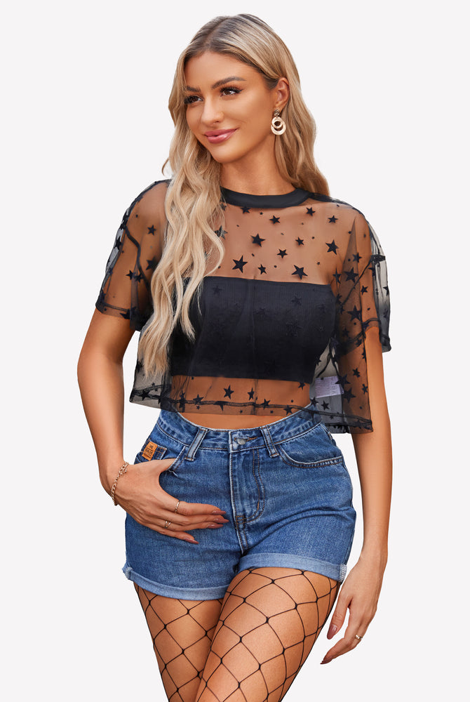 Black star mesh crop top, denim shorts, and fishnets. Trendy and sexy see-through top for women.