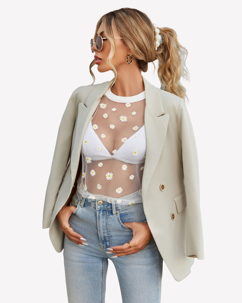 Daisy mesh crop top with white bralette, jeans, and blazer. Trendy see-through outfit.