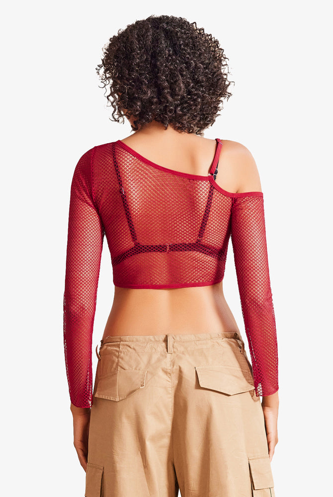Red fishnet asymmetrical crop top, see-through design, with bra and cargo pants, for a sexy look