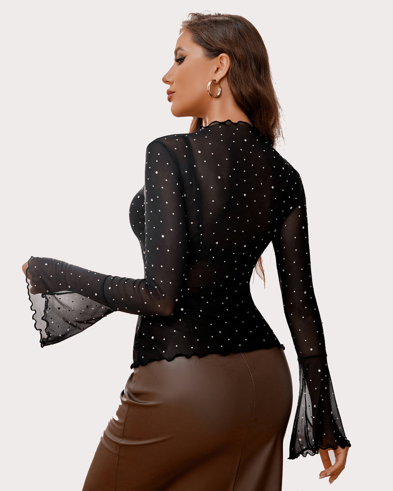 Black mesh rhinestone top with bell sleeves, mock neck, and ruffle hem, creating a sexy look.