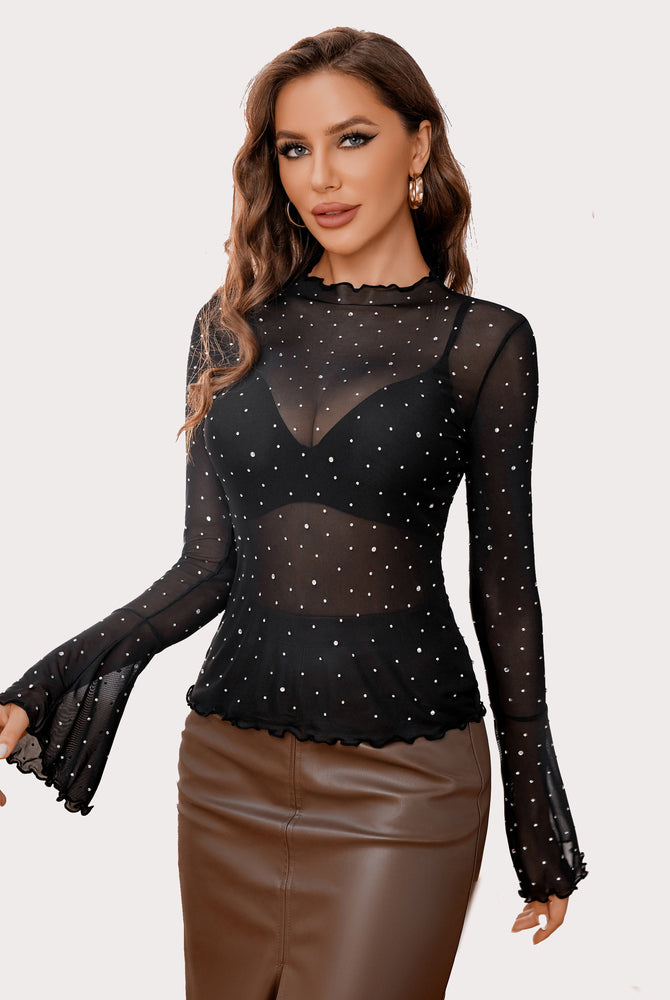 Black mesh top with rhinestones, mock neck, and bell sleeves. Sexy outfit creating a confident look.