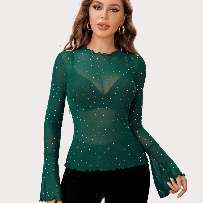 Emerald green mesh rhinestone top with mock neck and bell sleeves, creating a sexy look.