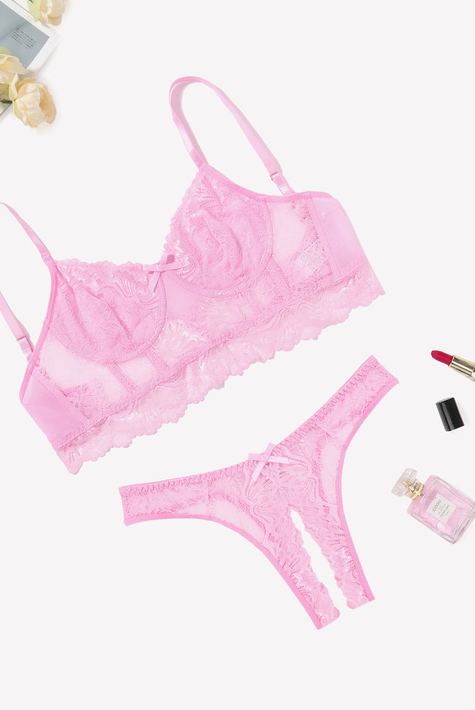Pink lace lingerie set with bra and crotchless panty, offering a flattering and sexy look.
